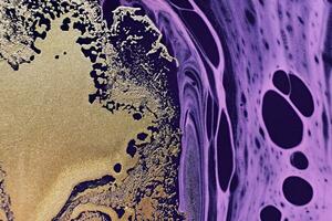 Fluid Art. Golden metallic abstraction and purple waves. Marble effect background or texture photo