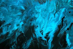 Fluid Art. Blue abstract wave swirls on black background. Marble effect background or texture photo