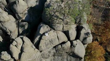 Wedding day of the newlyweds on the rocks. Flying a drone around a young couple who is standing on the rocks. video