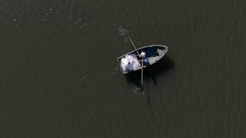 Aerial view Boat with brides on the background of the fabulous glare of the sun, which is reflected in the water of a large lake. video