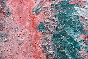 Fluid Art. Embossed strokes, craters and drips of pink and green paint. Marble effect background or texture photo