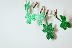 Happy St. Patricks day background with Green glitter shamrocks garland photo