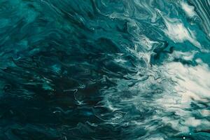 Fluid Art. Liquid dark turquoise abstract drips and wave. Marble effect background or texture photo