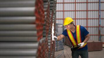 Warehouse worker in hard hats and helmets, Inspect and count steel in the warehouse. photo