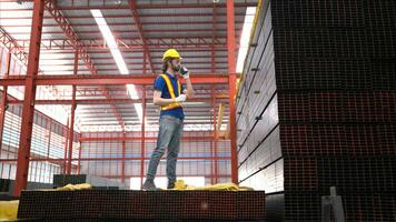 Warehouse worker in hard hats and helmets, Inspect and count steel in the warehouse. photo