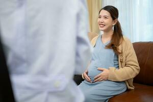 Father and daughter pregnant woman visit gynecologist doctor at medical clinic for pregnancy consultant. Doctor examine pregnant belly for baby and mother healthcare check up. photo