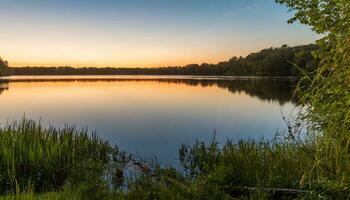 AI generated a lake at sunset with grass and trees photo