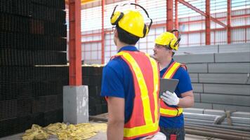 Warehouse workers in hard hats and helmets, Inspect and count steel in the warehouse. photo