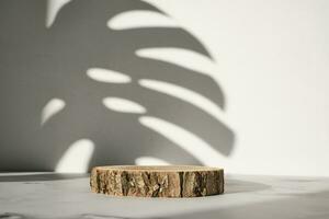 Wooden cut podium with monstera leaf shadow for natural cosmetics or products presentation photo