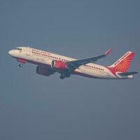 New Delhi, India, December 25 2023 - Air India Airbus A320 take off from Indra Gandhi International Airport Delhi, Air India domestic aeroplane flying in the blue sky during day time photo