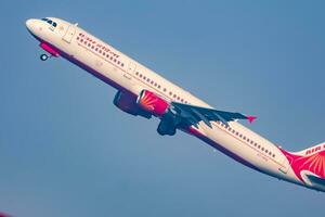 New Delhi, India, December 25 2023 - Air India Airbus A320 take off from Indra Gandhi International Airport Delhi, Air India domestic aeroplane flying in the blue sky during day time photo