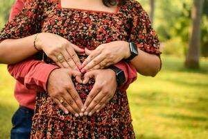 Indian couple posing for Maternity shoot pose for welcoming new born baby in Lodhi Road in Delhi India, Maternity photo shoot done by parents for welcoming their child, Pre Baby Photo Shoot