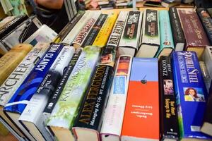 New Delhi, India, September 09 2023 - Variety of Books on shelf inside a book-stall at Delhi International Book Fair, Selection of books on display in Annual Book Fair. photo