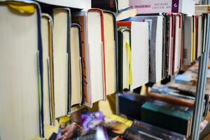 New Delhi, India, September 09 2023 - Variety of Books on shelf inside a book-stall at Delhi International Book Fair, Selection of books on display in Annual Book Fair. photo