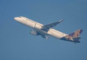 New Delhi, India, April 16 2023 - Vistara Airbus A320 neo take off from Indra Gandhi International Airport Delhi, Vistara domestic aeroplane flying in the blue sky during day time photo