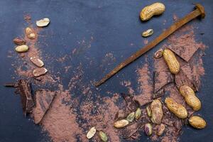 dark chocolate pieces mixed with cocoa powder photo