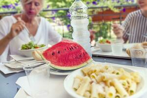 Modern mom and young daughter eating lunch photo