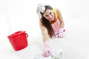 pretty woman with cloth and bucket cleaning the floor photo