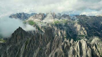 Aerial view of Cadini di Misurina mountains with Tre Cime di Lavaredo mountains in the background during a sunny day with some clouds. Dolomites, Italy. Dramatic and cinematic landscape. video