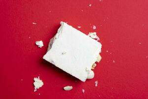 piece of Italian nougat over a red background photo