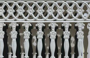 Abstract ornament and decorative pattern background of vintage white cast iron sliding fence gate in Roman style photo