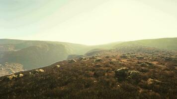 incredible photo of a misty rocky terrain with partial grass coverage video