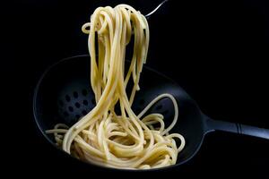 Italian spaghetti cooked in a colander photo