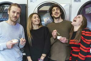 group of millennial friends are eating ice cream and washing clothes photo