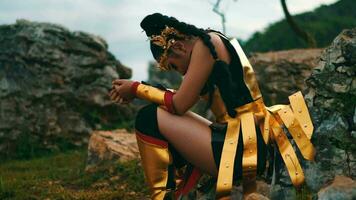 a female knight was resting and leaning against a boulder with a tired face video