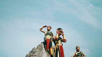 a group of royal knights was standing on a rock cliff while wearing golden armor costumes video