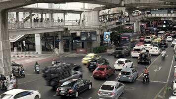 Time lapse of city street intersection with traffic jam at BTS Station. Transportation of the capital city center, business district dense with people and vehicles video