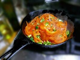 Saute of red bell pepers and jalapenos photo