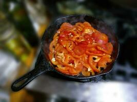 Saute of red bell pepers and jalapenos photo