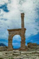 Column and arches of ancient Roman agora photo