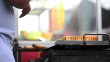 A toast seller is grilling toast called roti bakar bandung. video