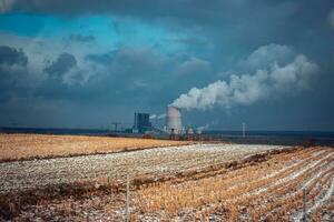 Panoramic view of nuclear power plant with wheat field Nuclear power plant cooling towers, big chimneys photo