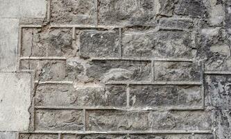 Close up old gray brick texture wall concept photo. Mediterranean architecture, urban city life photo