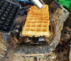 a waffle being cooked on a grill photo