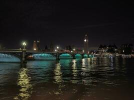 Houses of Parliament and Westminster Bridge at night in London photo