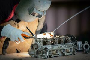 Welder is welding Tungsten Inert Gas welding, Welding aluminum with aluminum argon, TIG welding torch. photo