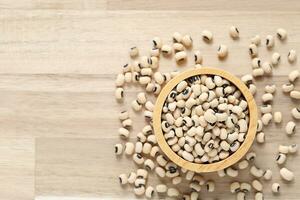 Top view of Black eyed beans in a bowl on wooder background, Healthy eating concept photo