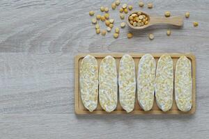 Raw tempeh, Top view of chickpeas tempeh in a bowl on wooder background, Healthy eating concept photo