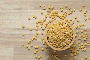 Top view of split soybeans in a bowl on wooder background, Healthy eating concept photo