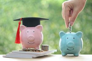 Graduation hat on piggy bank with stack of coins money on natural green background, Saving money for education concept photo