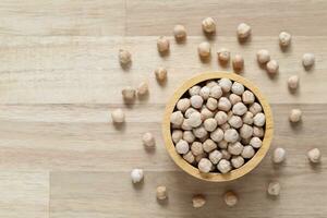 Top view of chick peas in a bowl on wooder background, Healthy eating concept photo