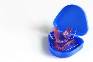 Acrylic dental retainer in box on white background, Healthy teeth and tooth hygiene concept photo