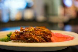 Grilled duck with cooked rice and pickled ginger photo