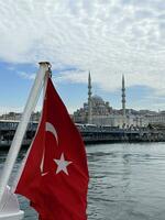 17 de abril 2023 - Estanbul, Turquía - turco bandera azul mezquita, ver desde el barco foto