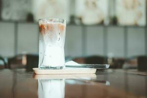 A glass of two layers iced mocha at nice coffee shop with space for text photo