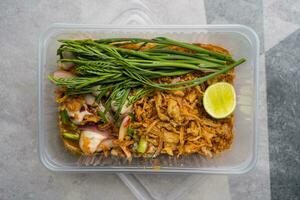 Fresh oysters in spicy salad topping with raw acacia, slice lemon and fried onions. photo